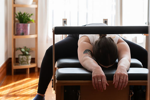 Cinzia stretching back on reformer machine