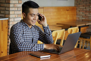 waist-up-shot-man-working-laptop-while-talking-phone.jpg