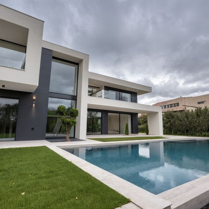 Modern villa, white stucco, dark grey composite siding, large glass windows, glass railings, infinity pool, light beige pool decking, manicured lawn,  Mediterranean pine trees,  flowering shrubs,  residential neighborhood, overcast day.