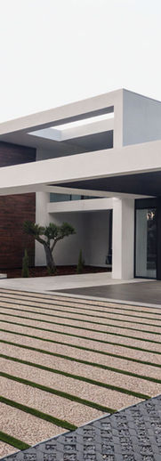 Modern house, white plaster, grey stone, dark wood, glass windows,  LED lighting, gravel driveway, artificial grass, pine trees, olive trees, landscaping, evening, soft light.