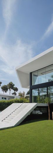 modern white stucco house, whit large stairs entrance, pool and garden, and front large window