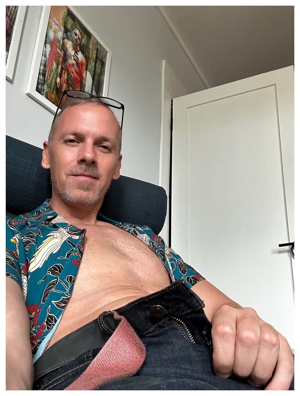 Eye-level view of a man receiving a calming shoulder massage in a softly lit room