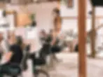 Coworking space with individuals focused on their tasks at modern desks, surrounded by an open, collaborative environment.