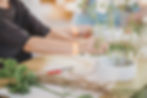 Person arranging white flowers in Ikebana Studio Ma workshop