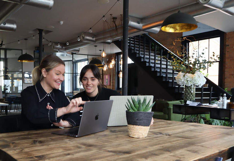Olya Black and Geenay Kotze watching at a desktop