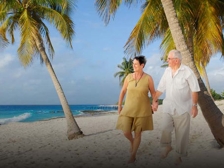A retired couple enjoying white sandy beaches.