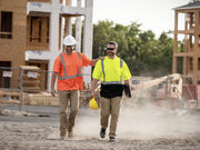 Construction workers with concrete buildings