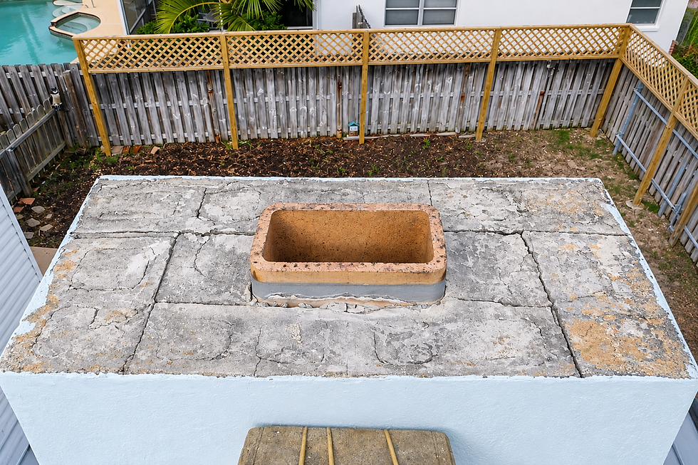 Deteriorated chimney crown with cracks and water damage
