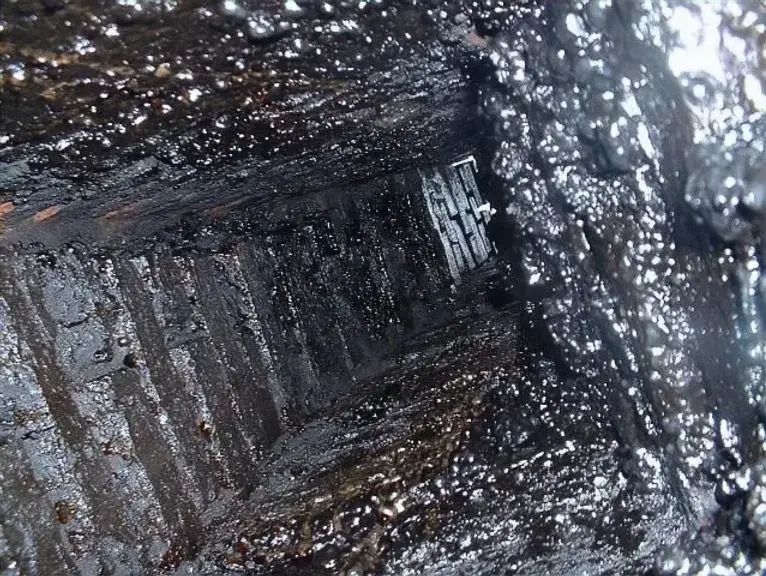Glazed creosote buildup inside a chimney flue