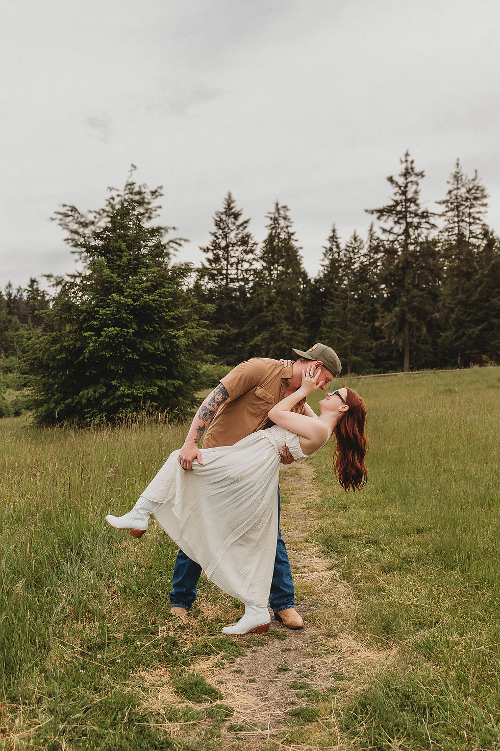 Medium shot of two people laughing together beside a wooden fence at Howe Farm.