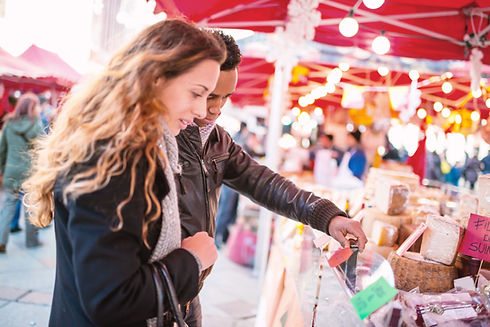 Couple Looking at Cheese at Market