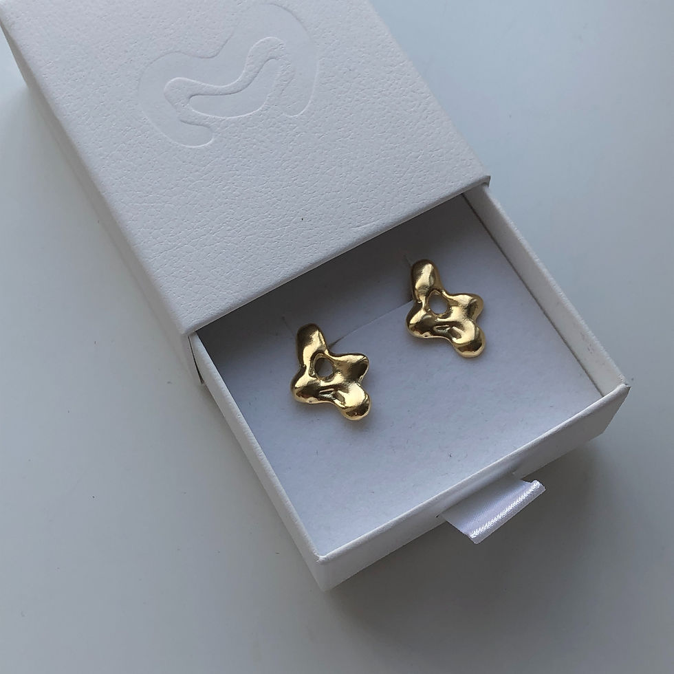 Thumbnail: Pair of gold-plated sculptural earrings with organic shapes, displayed inside a jewelry box.