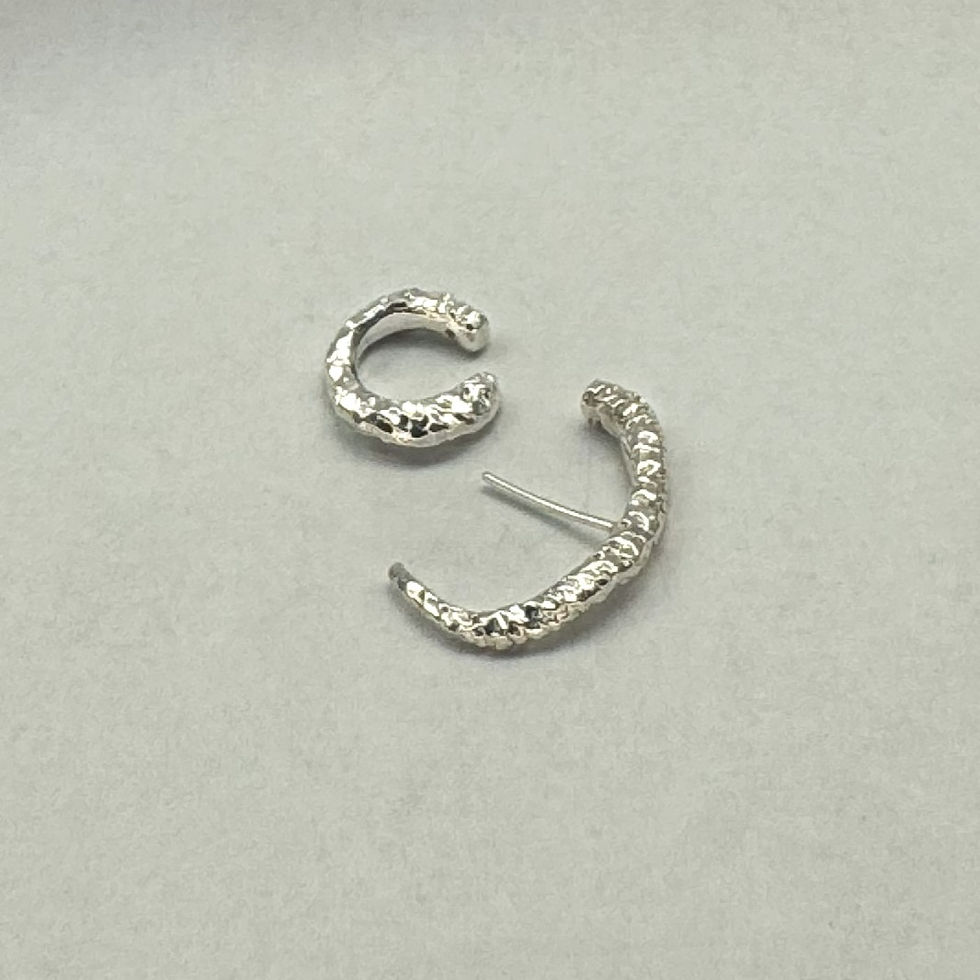 Thumbnail: Textured silver hoop and ear cuff on plain background