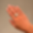 silver ring featuring the word “OK” in chunky design worn on a finger, shown against a plain background