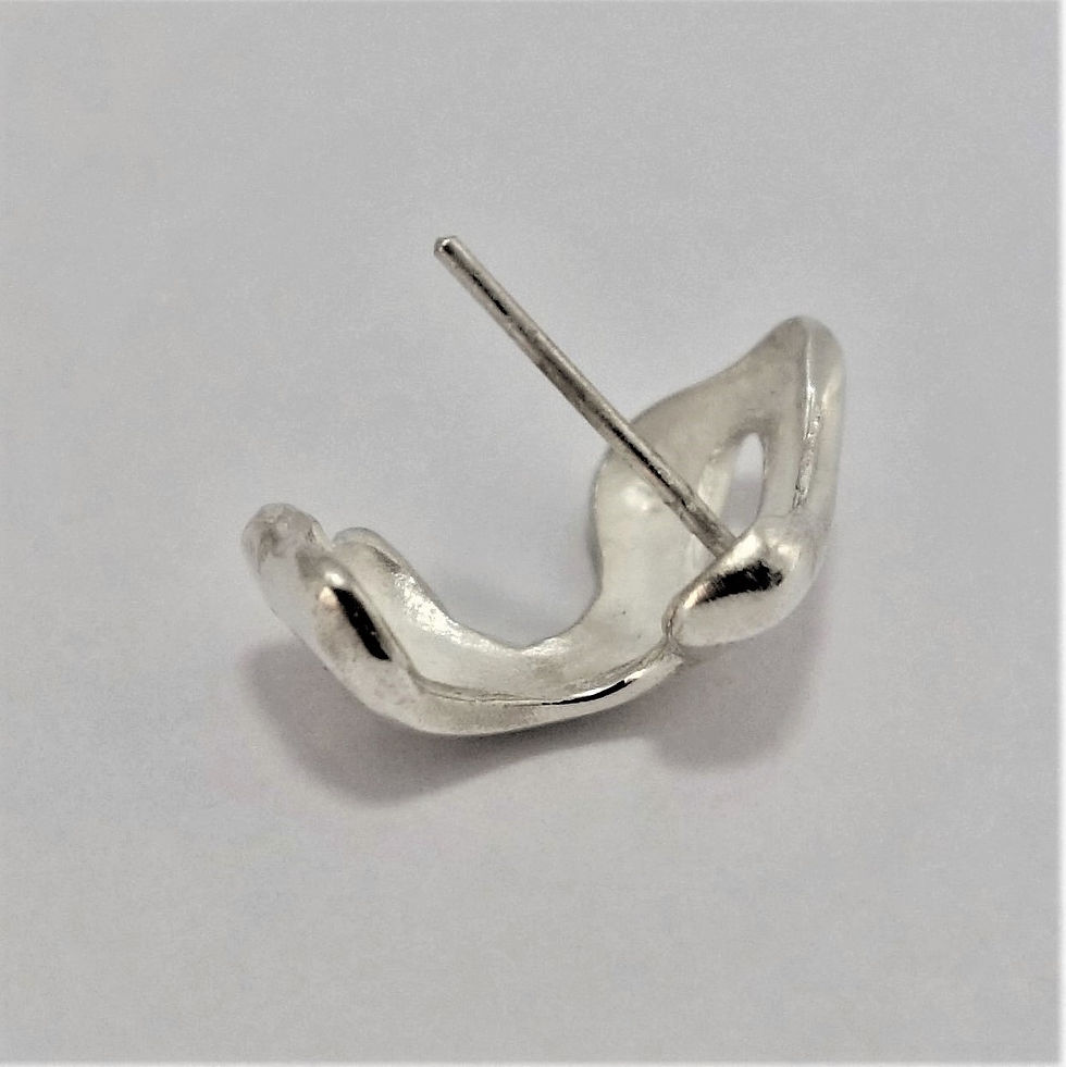 Thumbnail: Abstract silver earring with sculptural curves and a small cutout, shown on a plain background