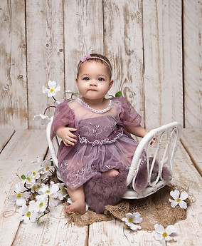 Six-month-old baby lying on tummy during milestone session Norbury