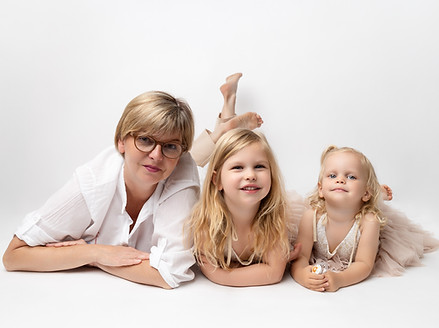 Grandmother hugging two children during family photoshoot in Norbury