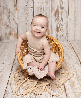 Baby playing with wooden toys during milestone photoshoot SW16