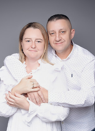 Relaxed family portrait on sofa during Tiny Teddies home studio session