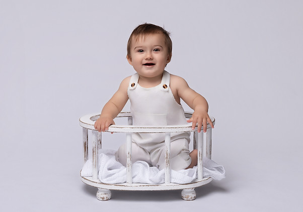 Milestone portrait of baby boy in cosy London studio setup