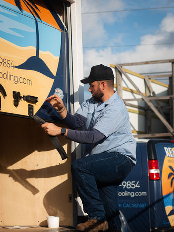 Man installing Desert Art truck wrap