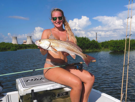 woman holding brown and white fish