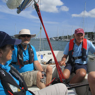 A visiting sailor at the helm of Echo.