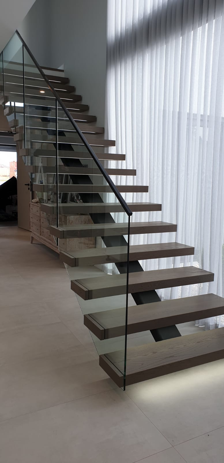 Custom stairs. Stairs Perth. Prestige stairs. Bespoke stairs. Timber stairs. Glass balustrade. Custom glass balustrade. Glass made by Cooling Brothers Glass. Steel spine. Steel spine stairs. Custom lighting. Led lighting. Smart lighting. Led tread lighting.