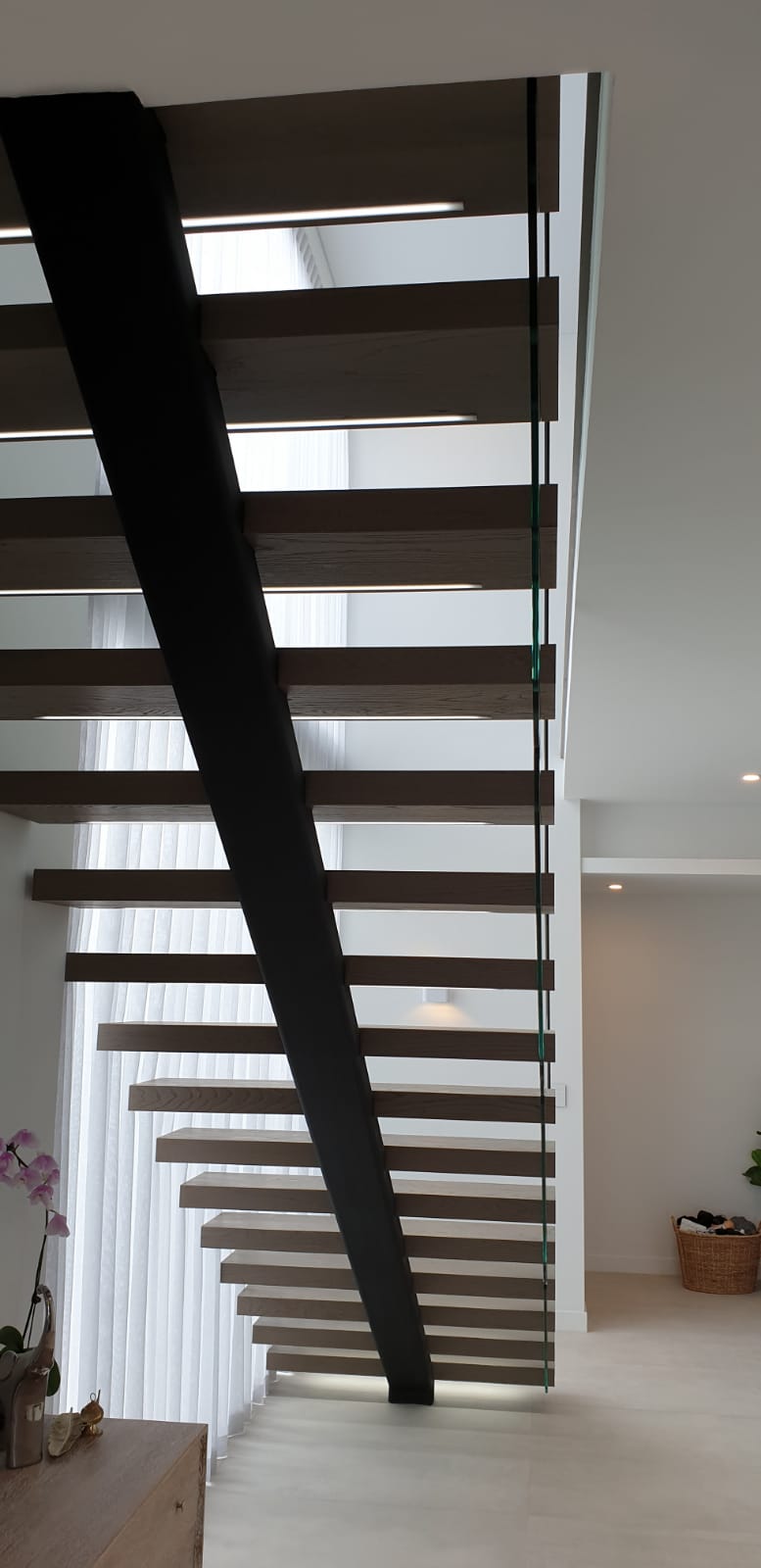 Custom stairs. Stairs Perth. Prestige stairs. Bespoke stairs. Timber stairs. Glass balustrade. Custom glass balustrade. Glass made by Cooling Brothers Glass. Steel spine. Steel spine stairs. Custom lighting. Led lighting. Smart lighting. Led tread lighting.