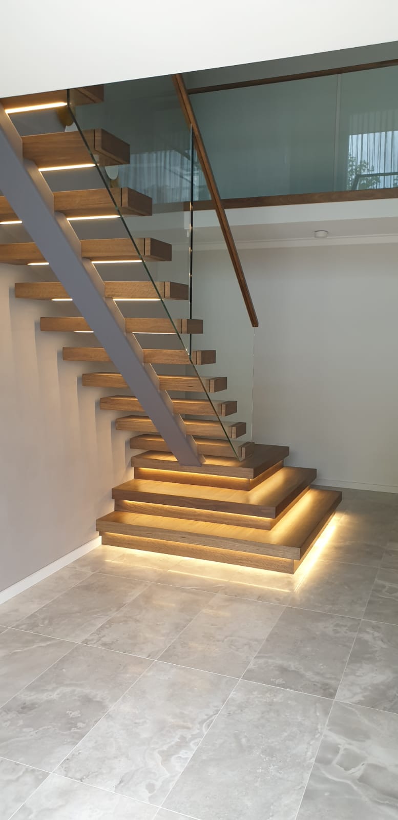 Steel spine. Steel spine stairs. Glass balustrade. Custom glass balustrade. Glass made by Cooling Brothers Glass. Custom stairs. Stairs Perth. Prestige stairs. Bespoke stairs. Timber stairs. Custom lighting. Led lighting. Smart lighting. Led tread lighting.