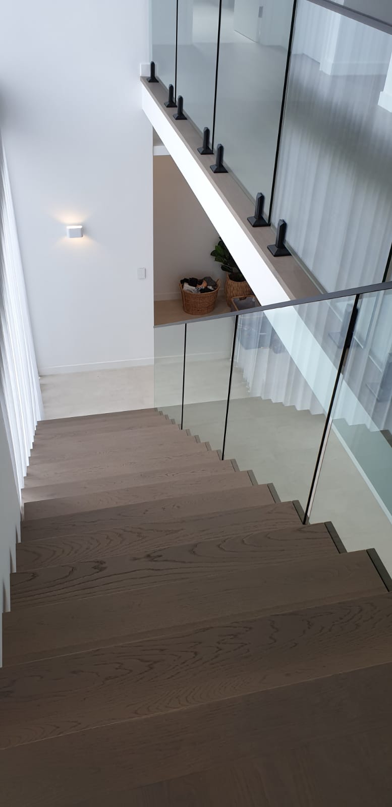 Custom stairs. Stairs Perth. Prestige stairs. Bespoke stairs. Timber stairs. Glass balustrade. Custom glass balustrade. Glass made by Cooling Brothers Glass. Steel spine. Steel spine stairs. Custom lighting. Led lighting. Smart lighting. Led tread lighting.