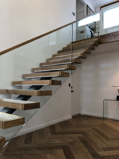 Custom stairs Perth. Steel spine stairs. Timber treads.  Glass balustrade. Custom glass balustrade made by Cooling brothers. Custom timber handrail