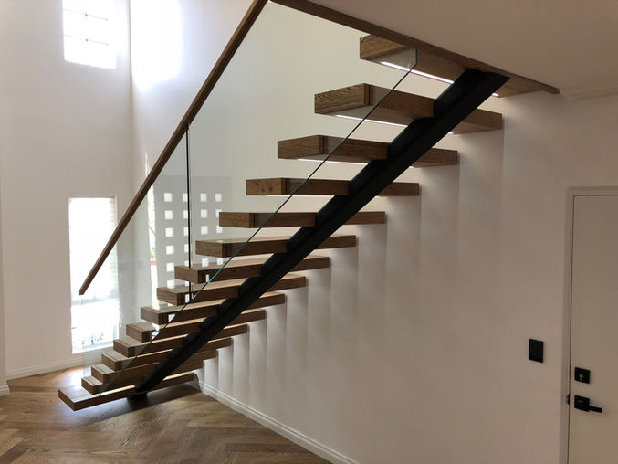 Custom stairs Perth. Steel spine stairs. Timber treads.  Glass balustrade. Custom glass balustrade made by Cooling brothers. Custom timber handrail