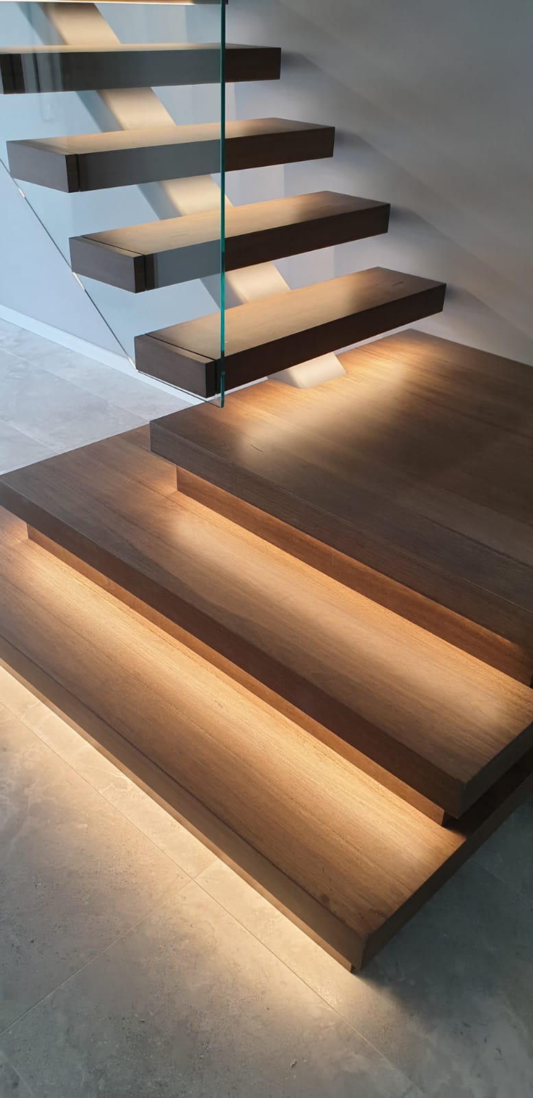 Steel spine. Steel spine stairs. Glass balustrade. Custom glass balustrade. Glass made by Cooling Brothers Glass. Custom stairs. Stairs Perth. Prestige stairs. Bespoke stairs. Timber stairs. Custom lighting. Led lighting. Smart lighting. Led tread lighting.