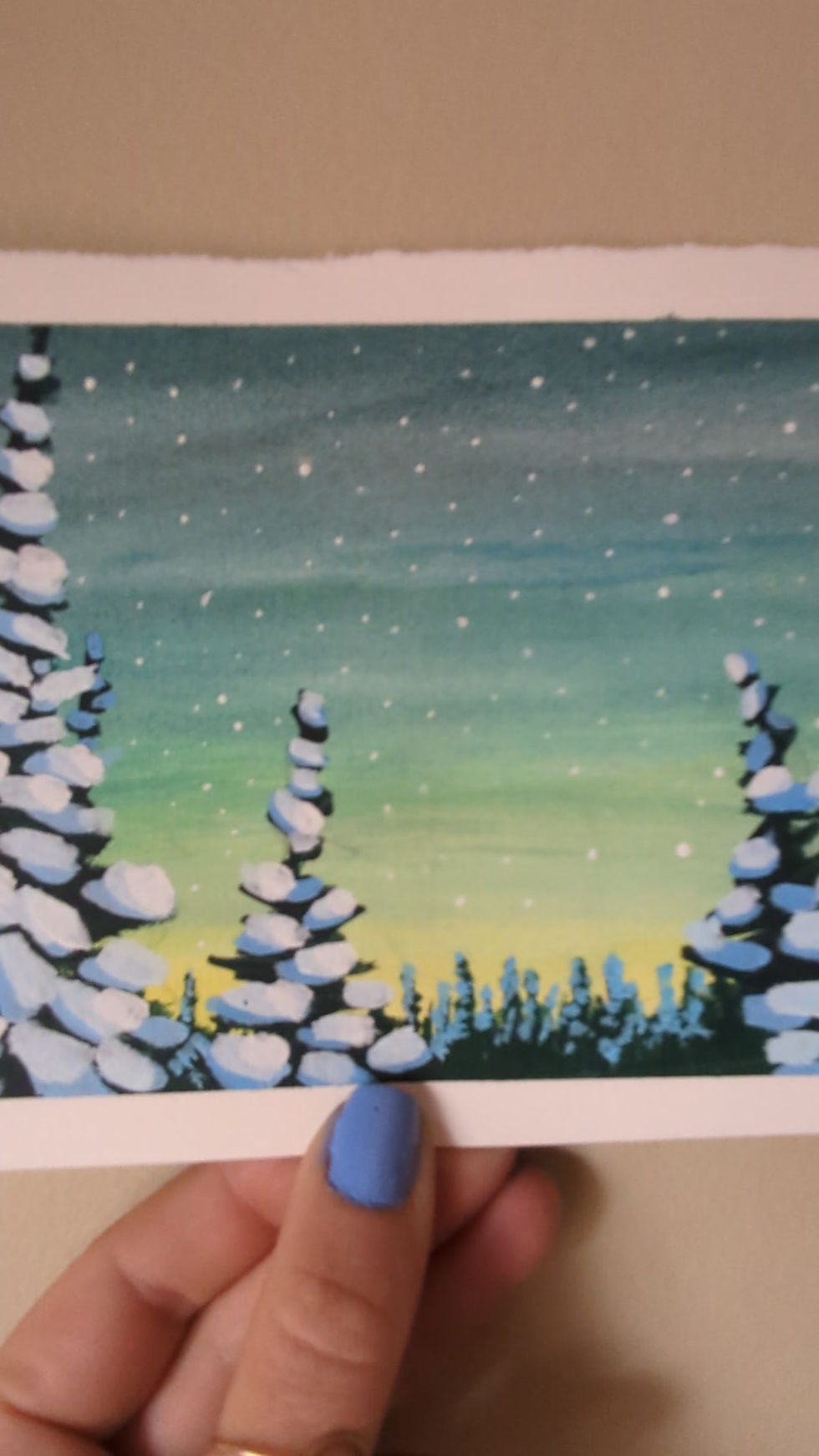 Thumbnail: video of acrylic painting of a teal blue sky and yellow sun coming up over snowy pine tree forest while snowing