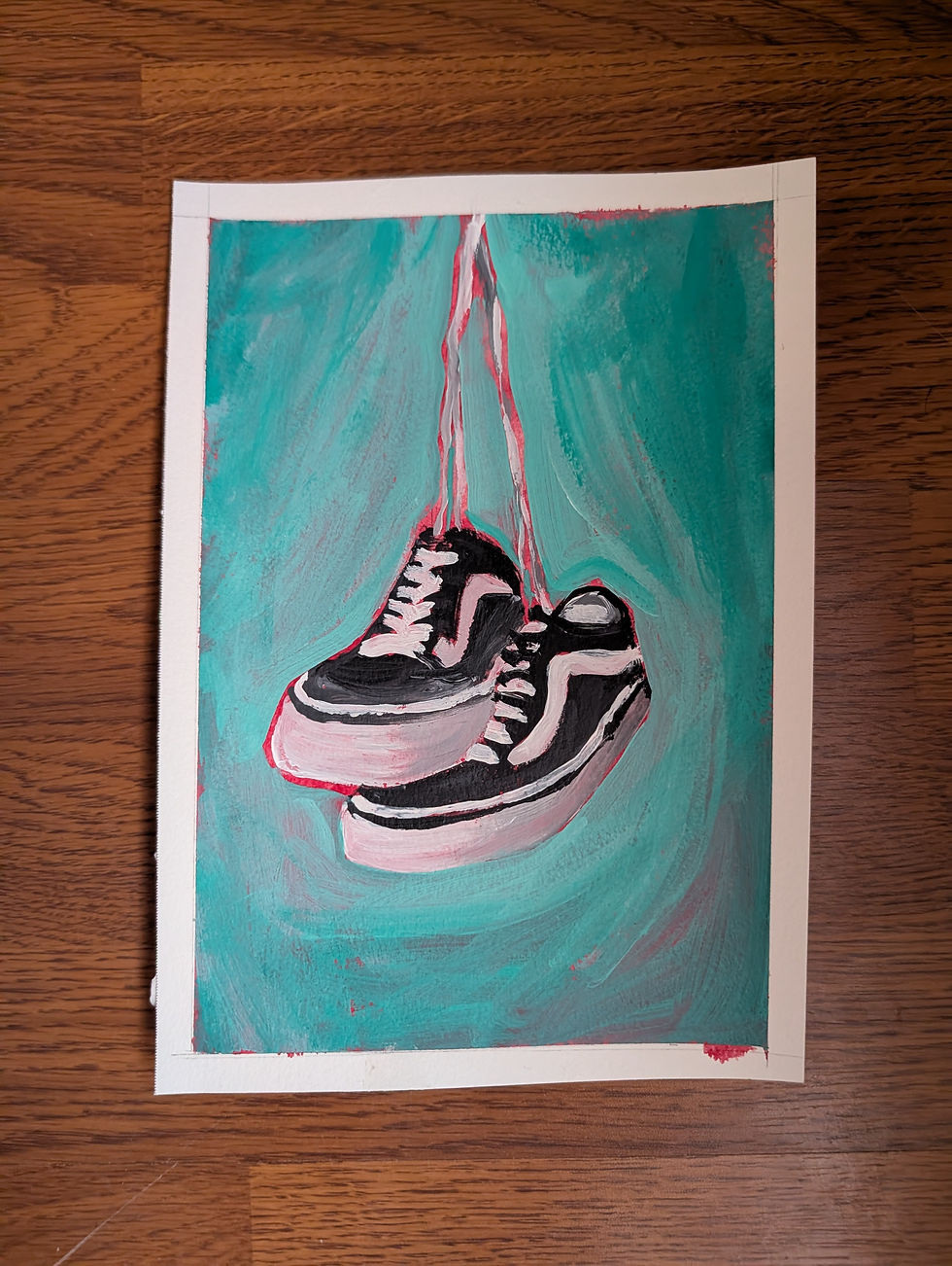 Thumbnail: A pair of Vans sneakers hanging by their laces, painting on hardwood.