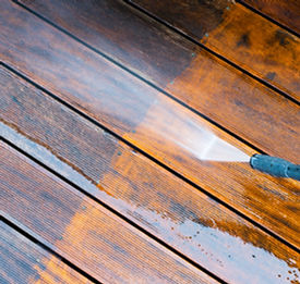 Pressure washing a wooden deck clean