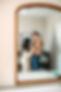 Reflection of mom, dad and baby in nursery mirror