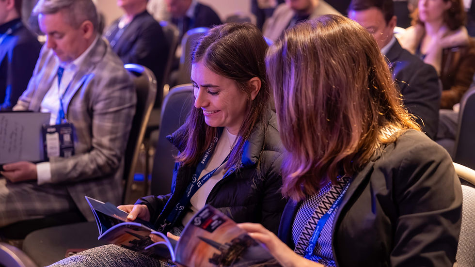 Conference delegates reading the Insurtech Insights programme, captured through candid corporate event photography