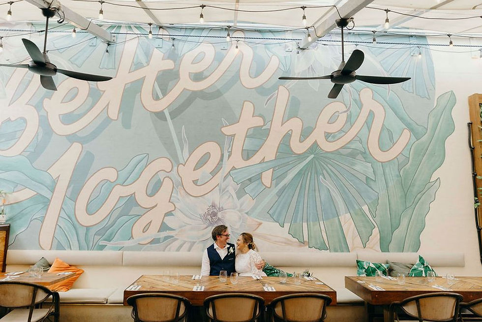 Better Together mural behind newly weds