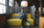Man sitting in a private breakout space in an office environment