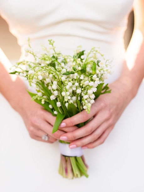 bride holding a Lily of the Valley bouquet