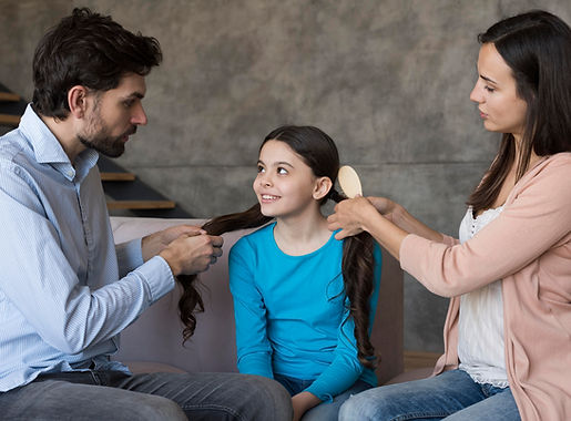 parents-brushing-daughter-hair.jpg
