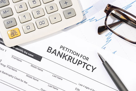 bankruptcy-form-calculator-pen-desk-personal-injury-claim-form-top-view.jpg