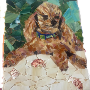 Brown dog mosaic with shells and a blue collar. Dog with Shells Mosaic. Green leafy background.