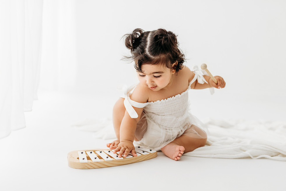 Baby girl playing xylophone 
