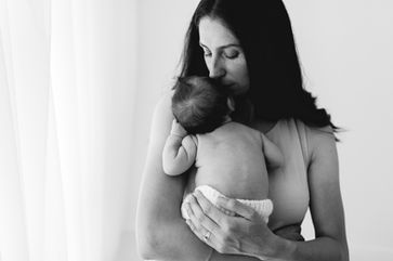 mother kissing her baby during newborn photoshoot in Melbourne