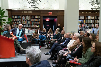 Rachel and Bill speak before a crowd.