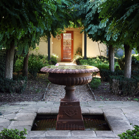 The fountain leading down to the pool pavilion