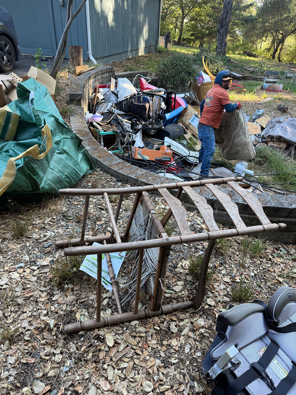 Close-up view of workers loading debris into a dumpster